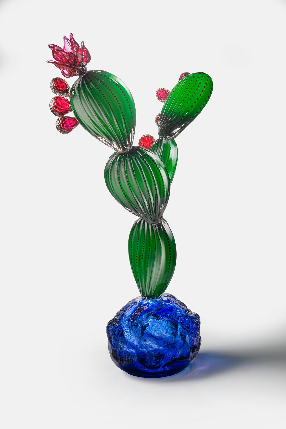 Nopal 2026, glass prickly pear cactus sculpture on a cobalt base by Manolo Aguilera