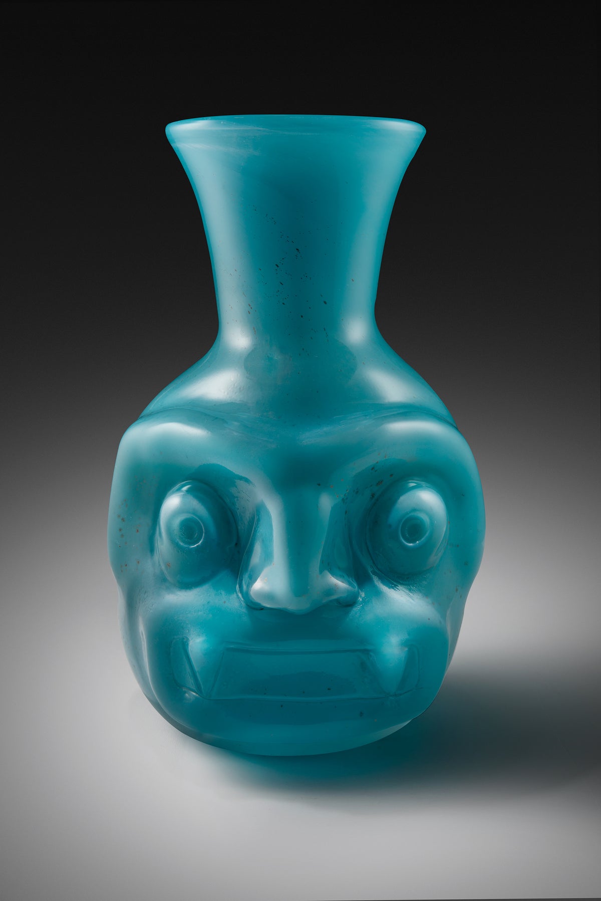 Tlaloc Vasija, turquoise glass vessel with a sculpted face by Manolo Aguilera