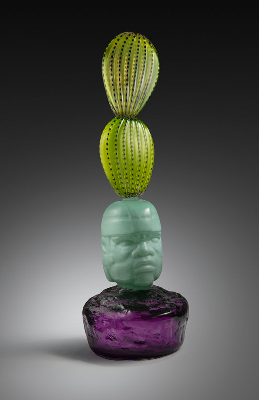 Ancestral Roots glass sculpture: green cactus forms atop a sea-green head on a purple base