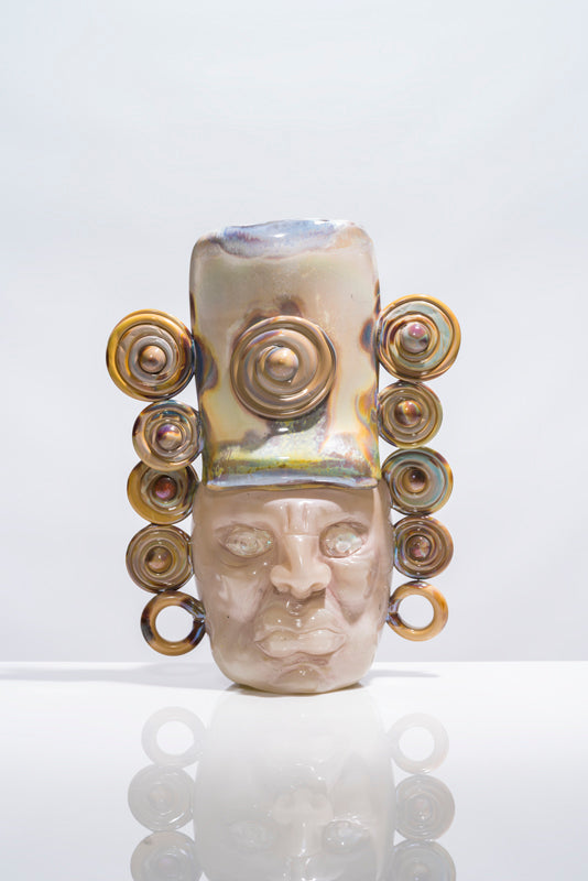 Mixteco, glass vessel sculpture with a sculpted face and iridescent spiral ornaments by Manolo Aguilera