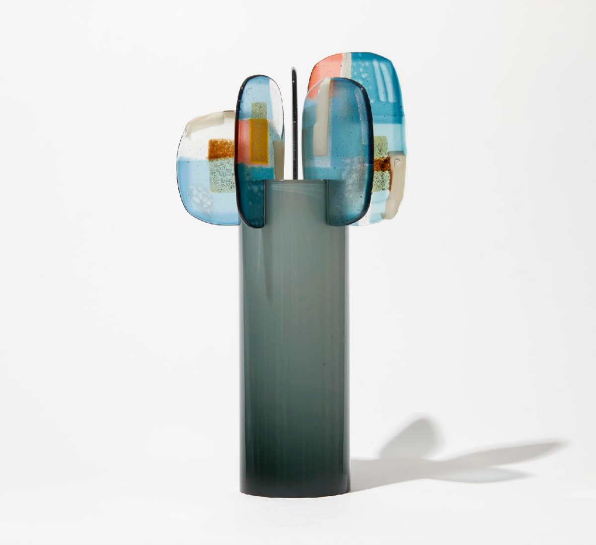 Midnight by Amy Cushing, smoky blue-green glass sculpture with layered multicolored kiln-formed finials.